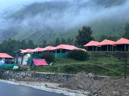 a group of tents on the side of a mountain at Buddy Hikers Stay Badrinath in Badrīnāth