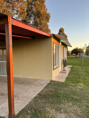 a small house with a red roof at La Leontina in Villa Elisa
