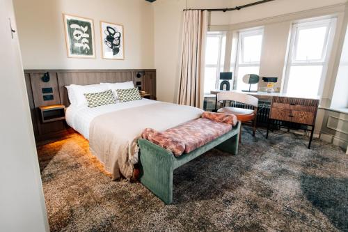a bedroom with a bed and a desk at The Nines in Bangor