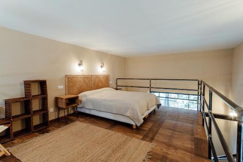 a bedroom with a bed and a staircase in it at Fajnové apartmány in Vyhne