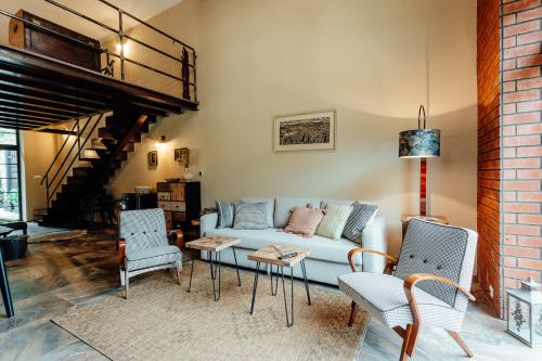 a living room with a blue couch and chairs at Fajnové apartmány in Vyhne