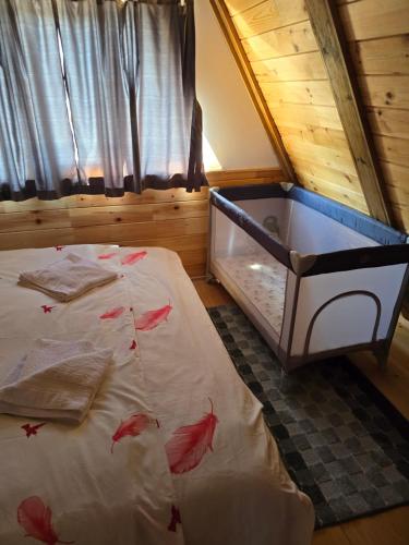 a bedroom with a bed with red leaves on it at Apartmani Cvijeta in Žabljak