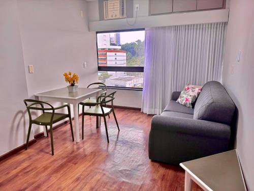 a living room with a couch and a table at Ondina Apart Hotel Residences in Salvador