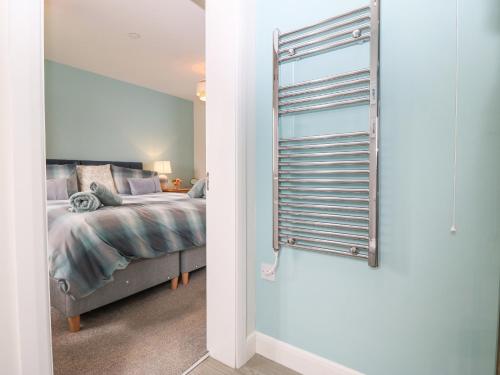 a bedroom with a bed next to a window at 7 Parc Delfryn in Brynteg