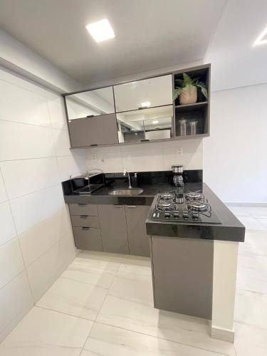 a kitchen with a stove and a counter top at Mardisa Design by Jess Hospedagens in João Pessoa