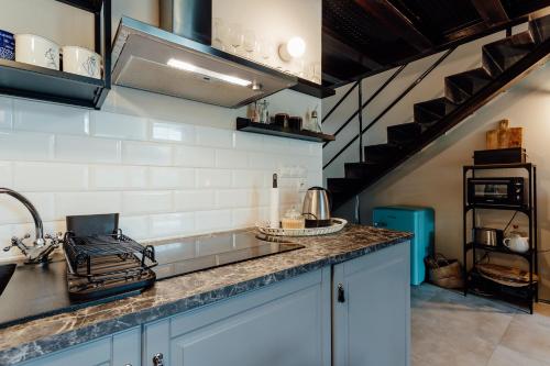 a kitchen with a sink and a counter top at Fajnové apartmány in Vyhne
