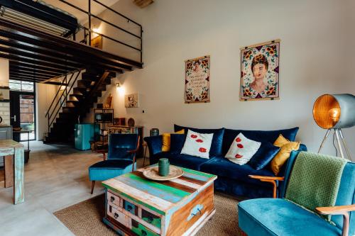 a living room with blue couches and a table at Fajnové apartmány in Vyhne