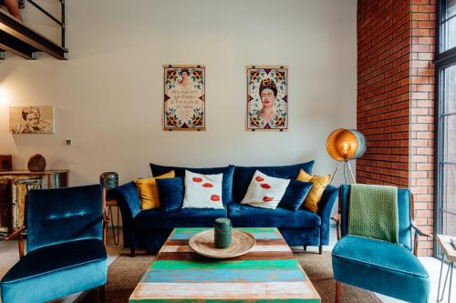 a living room with blue couches and a table at Fajnové apartmány in Vyhne