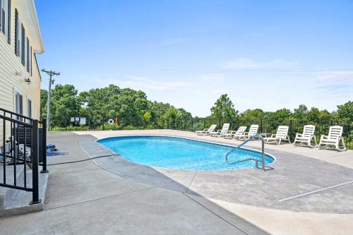 a swimming pool with lounge chairs and a pool at Big Family Lodge near ARK Sleeps 16 in Williamstown