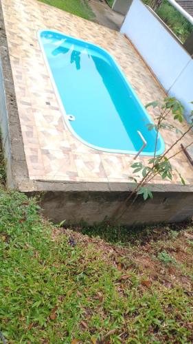 a swimming pool sitting on top of a brickickedickedickedfficient at ESPAÇO ShEHERAZADE PISCINA & LAZER in Juquitiba