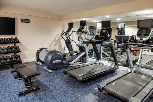 a gym with several treadmills and cardio machines at Delray Sands Resort in Boca Raton