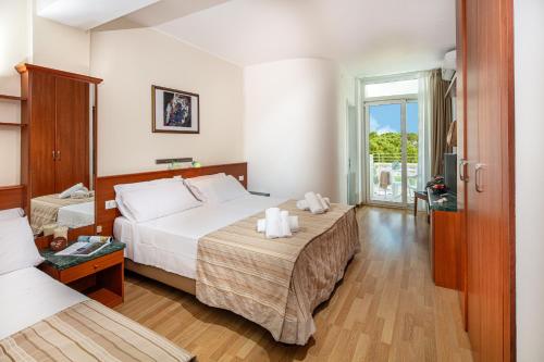 Postel nebo postele na pokoji v ubytování Hotel Bembo