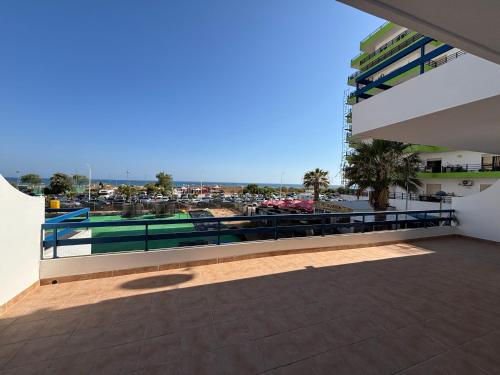 a balcony of a building with a swimming pool at Monte Gordo South Pearl Apartment in Monte Gordo