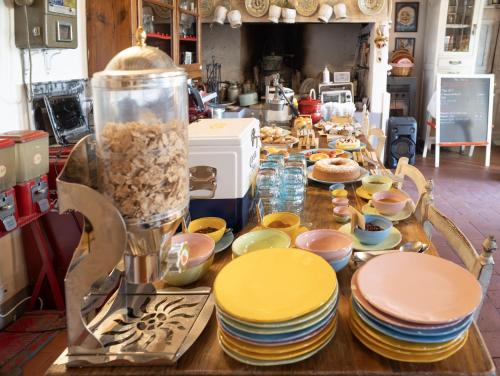 a table with plates and bowls on top of it at Le Terrazze Del Chianti b&b Residenza d'Epoca e di Charme in Tavarnelle in Val di Pesa