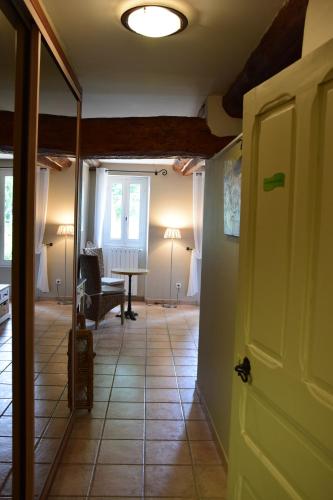 a hallway with a living room with a table at La Chambre des Amis au Moulin des GYPSES, Ventoux in Mormoiron