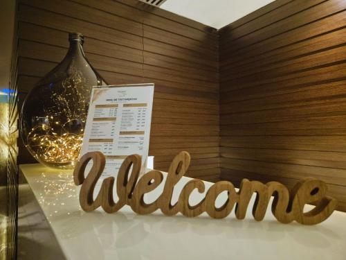 a welcome sign on a table with a bottle of wine at VIP Grand Lisboa Hotel & Spa in Lisbon