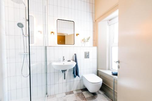 a bathroom with a sink and a toilet and a mirror at The Nines in Bangor