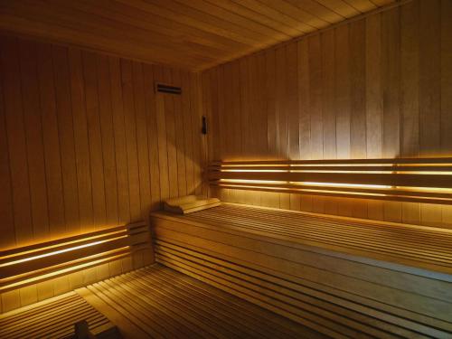 an empty sauna with wood paneling and lights at VIP Grand Lisboa Hotel & Spa in Lisbon