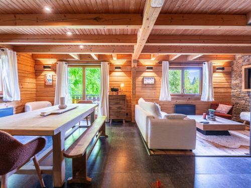 a living room with a table and some chairs at BOIS DE CHAMPELLE - 28 - Sublime CHALET 8 Pers in Morillon