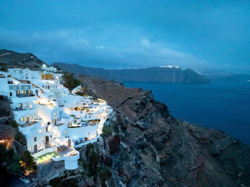 an aerial view of white buildings on a cliff at IKIES Santorini in Oia