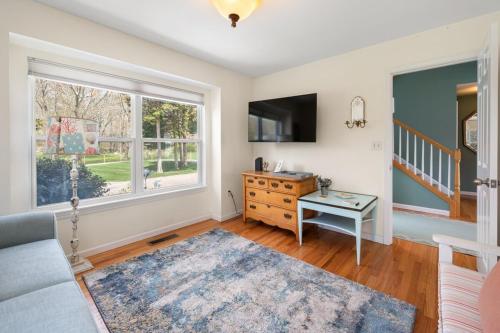 a living room with a couch and a window at 37 Wamphassuc Rd Chteau Stonington in Stonington