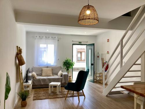 a living room with a couch and a staircase at Cais Inn in Horta