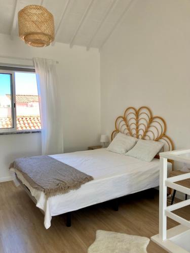 a bedroom with a large bed with a wooden headboard at Cais Inn in Horta