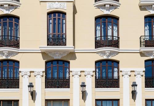 a facade of a building with windows at Catalonia Ronda in Ronda