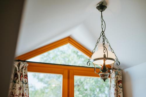 a chandelier hanging in front of a window at Penzion U maléřa in Hroznová Lhota
