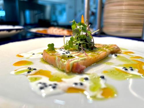 a white plate with a piece of food on it at Ramada by Wyndham Madrid Getafe in Getafe