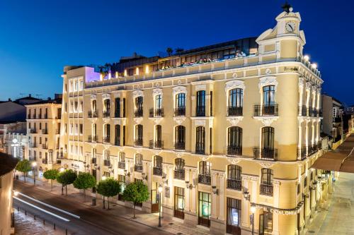 a large building on a street at night at Catalonia Ronda in Ronda