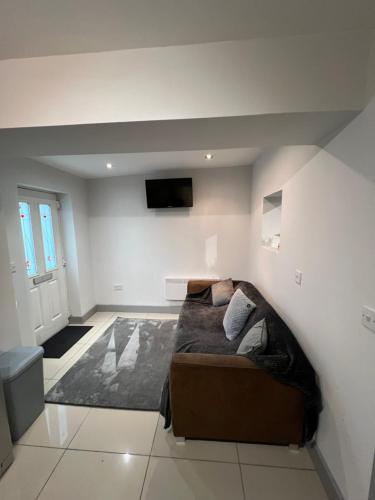 a bedroom with a bed and a tv on the wall at Cairo Street Ground New in Warrington
