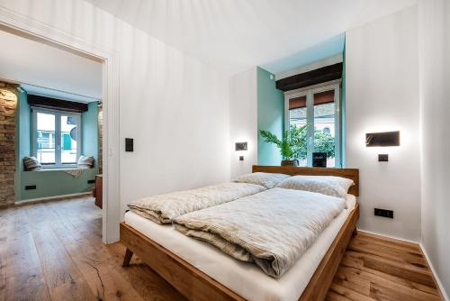 a bedroom with a large bed with white walls at Kubaliebe in Allensbach