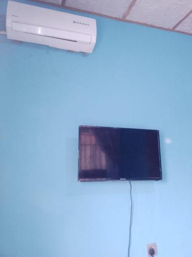 a television on a wall in a room at Cozy quiet 1 bedroom with kitchen in Ibadan