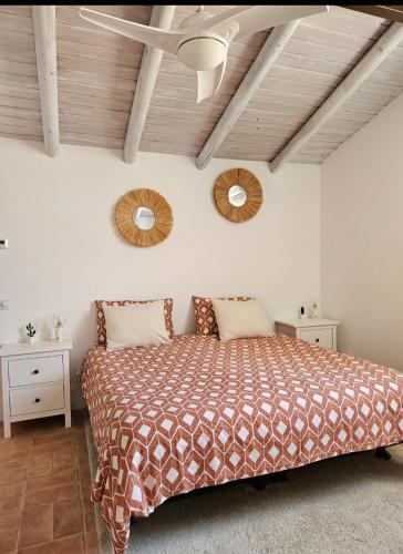 a bedroom with a bed and two mirrors on the wall at Casa Aventura in Boliqueime