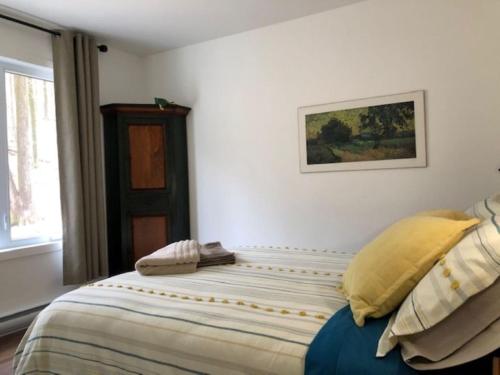 a bedroom with a bed with yellow pillows at Rooms in peaceful nature settings in Sutton