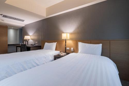 Postel nebo postele na pokoji v ubytování Guide Hotel Taipei Chongqing
