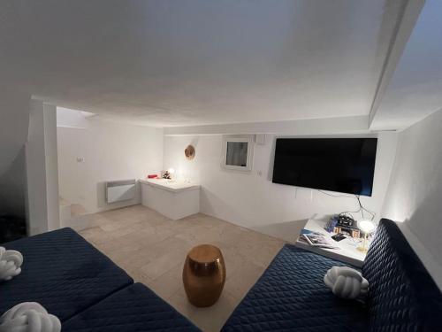 a bedroom with a bed and a tv on the wall at Fishermans House Saint Tropez in Saint-Tropez