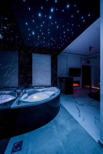 a large bathroom with a tub and a sink at Bounce Belgrade Apartment in Vračar (historical)