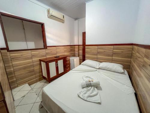 a bedroom with a bed with a towel on it at Pousada Territorial- Segunda praia MSP in Morro de São Paulo