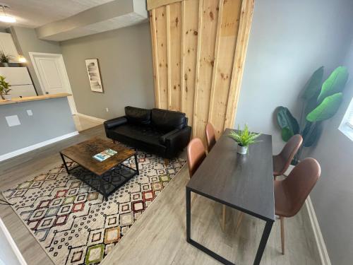 a living room with a table and a chair at The Yale Townhouse- 2 BR in Columbus