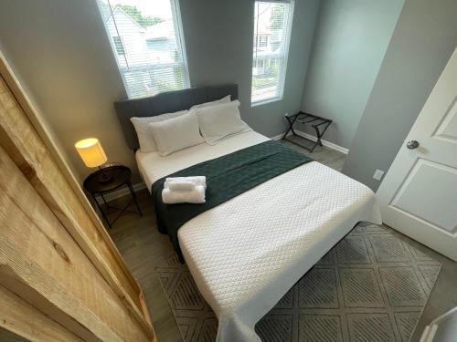 a bedroom with a bed with white sheets and pillows at The Yale Townhouse- 2 BR in Columbus
