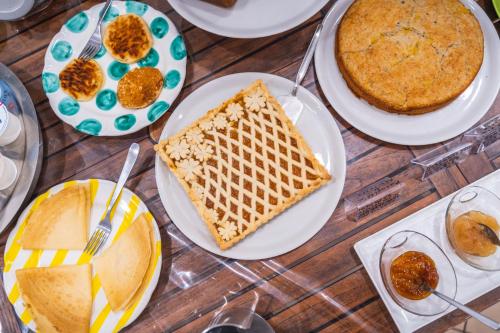 a table topped with plates of food and a cake at Oleum in Massa Lubrense
