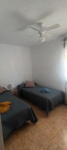 a bedroom with two beds and a ceiling fan at adosado con piscina en Cabo de Gata 6p in El Cabo de Gata