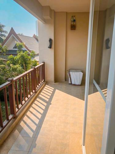 a balcony with a view of a house at คอนโดบ้านทะเลสำราญ in Cha Am