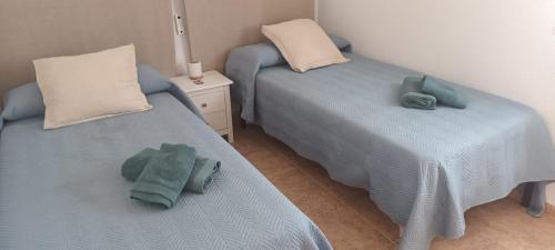 two twin beds in a room with towels on them at adosado con piscina en Cabo de Gata 6p in El Cabo de Gata