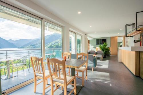 a kitchen and living room with a table and chairs at Panoramic Hotel San Carlo Ledro in Ledro