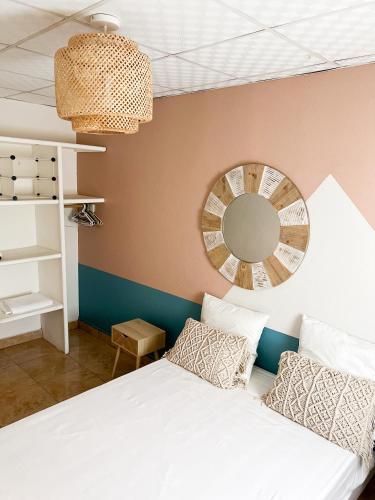 a bedroom with a white bed and a mirror at Tropicalme Pamandzi in Pamandzi
