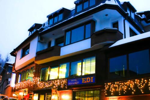 a building with christmas lights on the side of it at Family Hotel EDI in Sofia