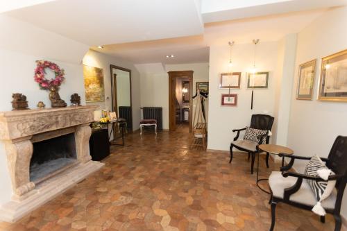 a living room with a fireplace and chairs at VILLA VEIO in Sacrofano